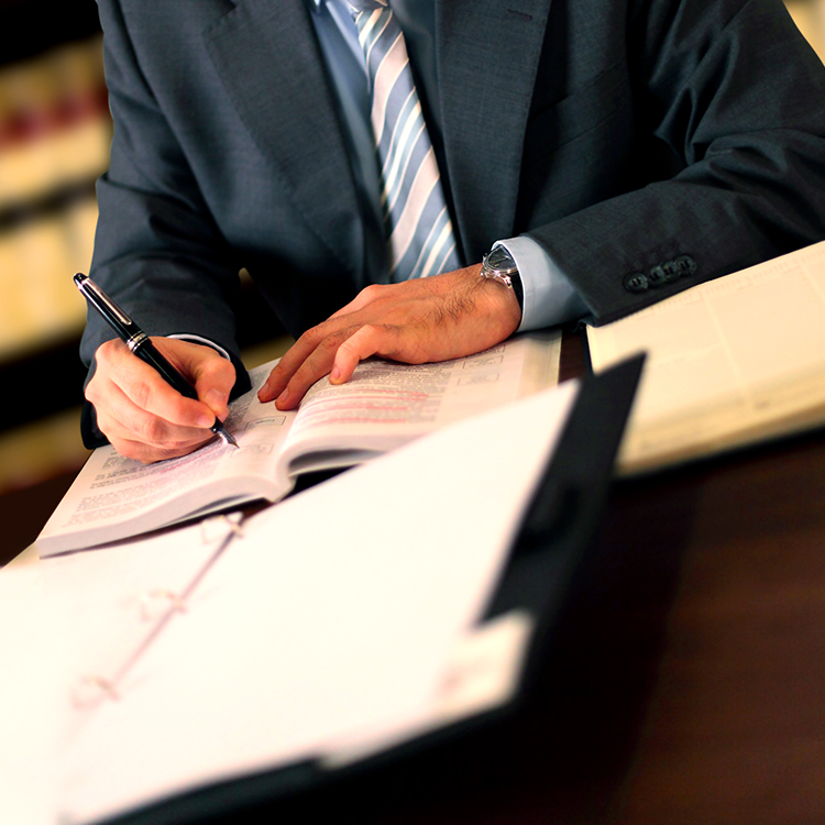 An attorney signing paperwork