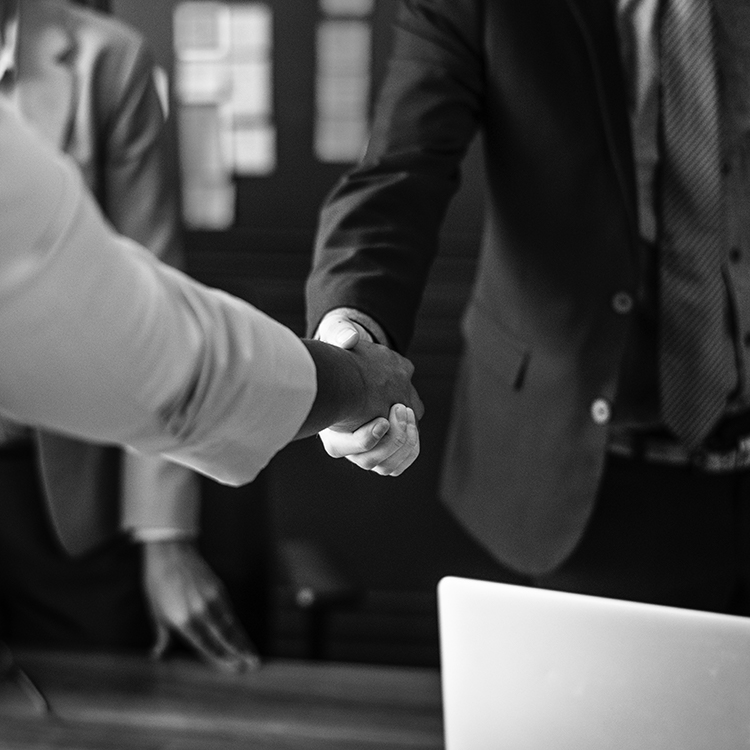 A private investigator shaking hands with a client after they closed a successful case